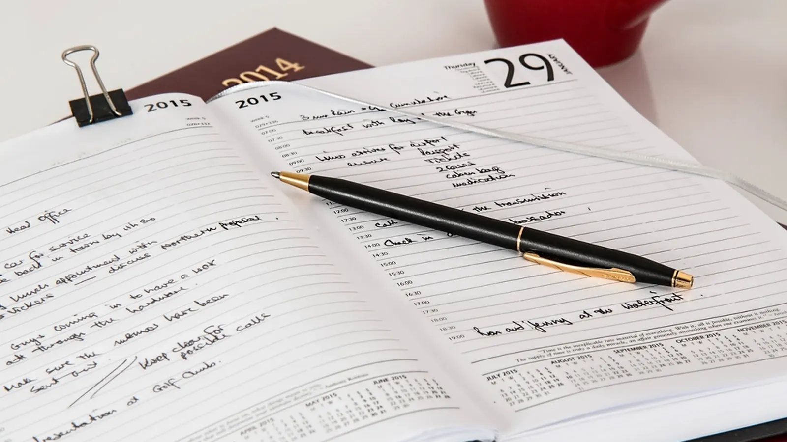 Open appointment planner with a pen on top