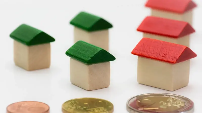 Small model houses and coins