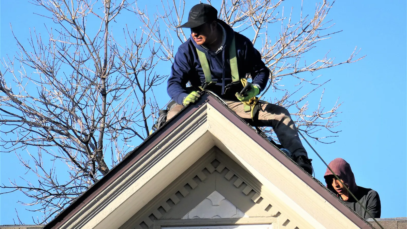 Roofer working on top of a house
