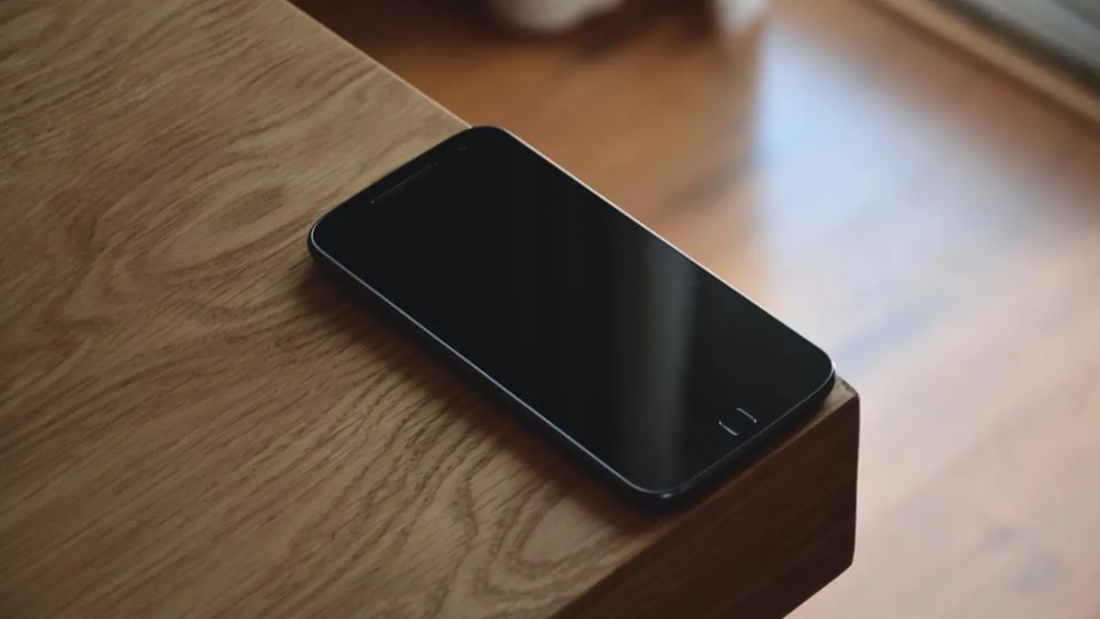 Smartphone lying on a wooden desk