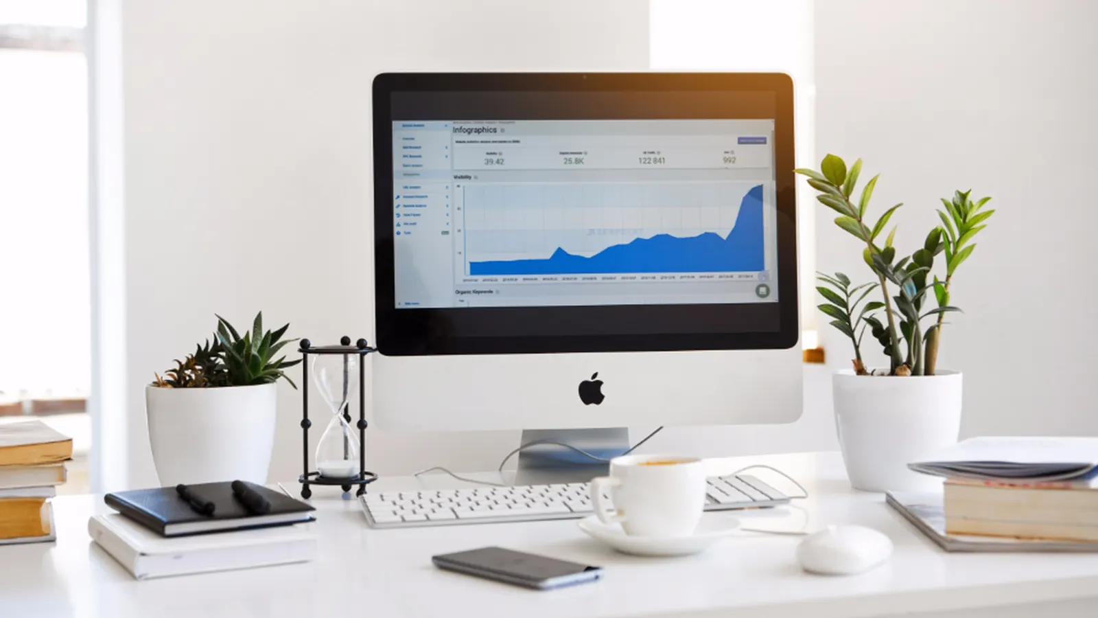 Desktop computer showing an analytics chart on a bright desk