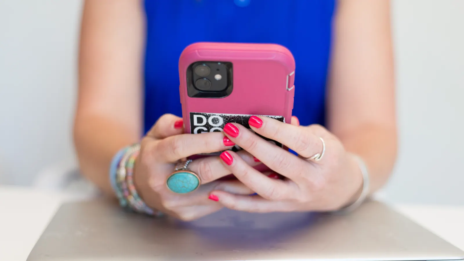 Person holding a smartphone in a pink case