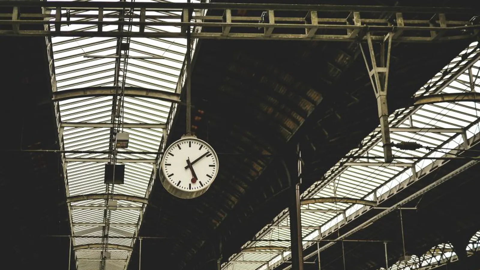 Large clock hanging in a train station