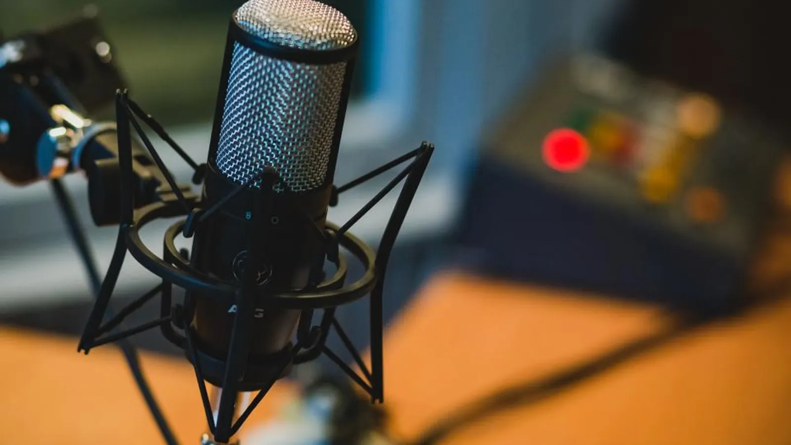 Studio microphone on a stand in front of recording equipment